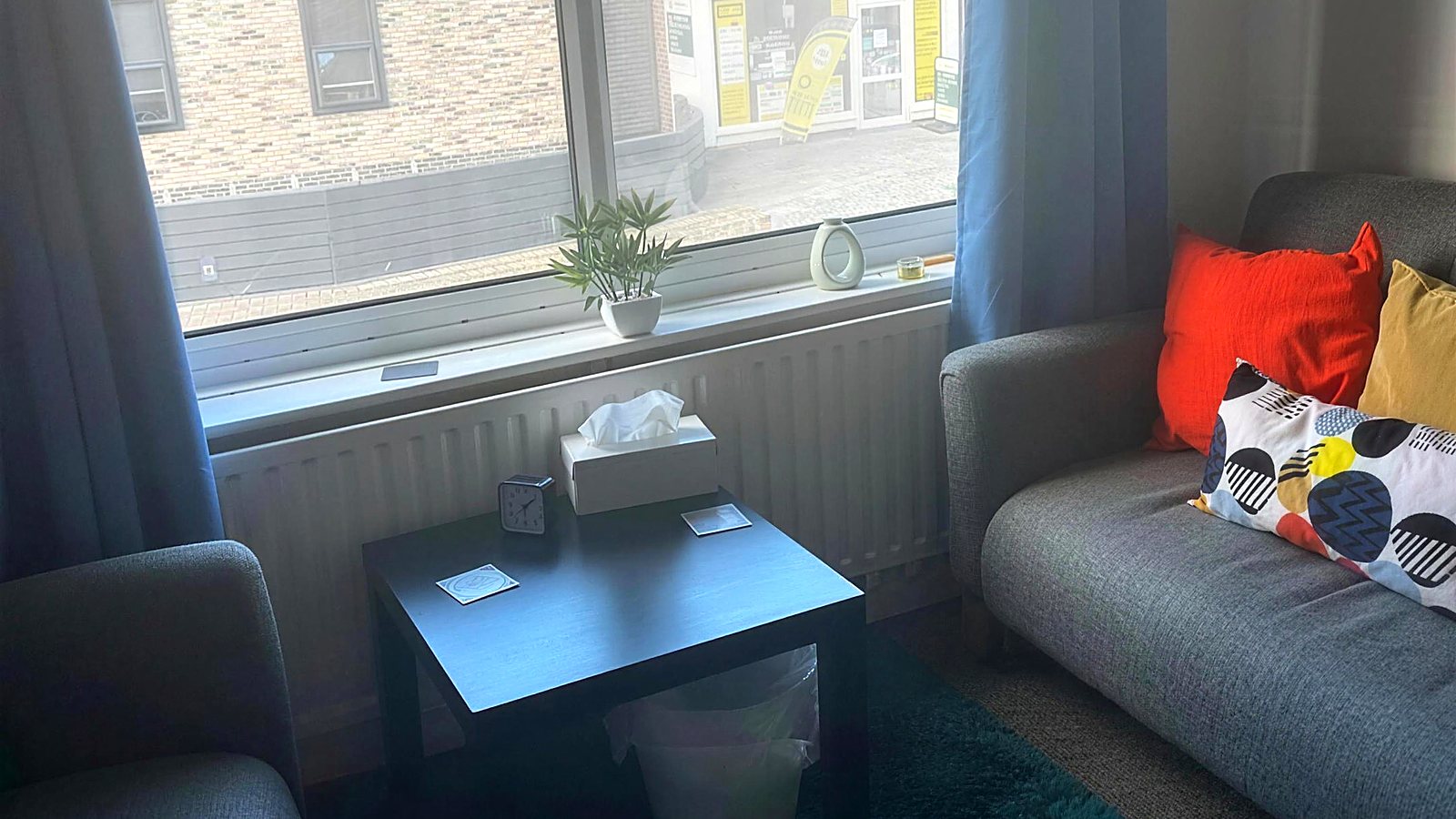 A counselling room at New Dawn — armchairs, a sofa and a box of tissues by the window